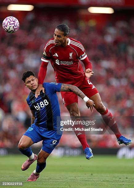 Virgil van Dijk of Liverpool wins a header before Alex Scott of AFC Bournemouth during the Premier League match between Liverpool and Bournemouth at...