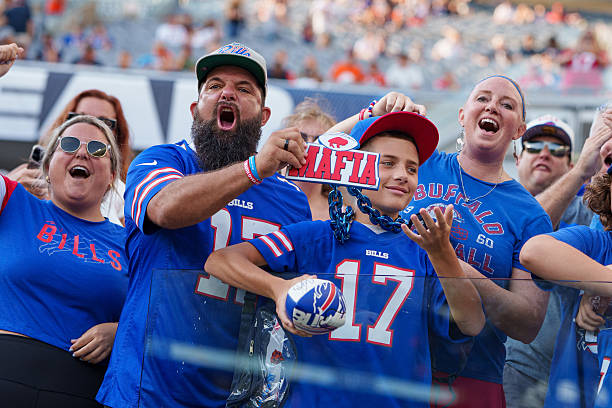 Buffalo Bills fans known as the Bills Mafia cheer in the stands prior to an NFL preseason football game against the Chicago Bears at Solider Field on...