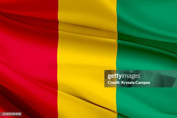 flag of guinea on fabric texture - kankan region stock pictures, royalty-free photos & images