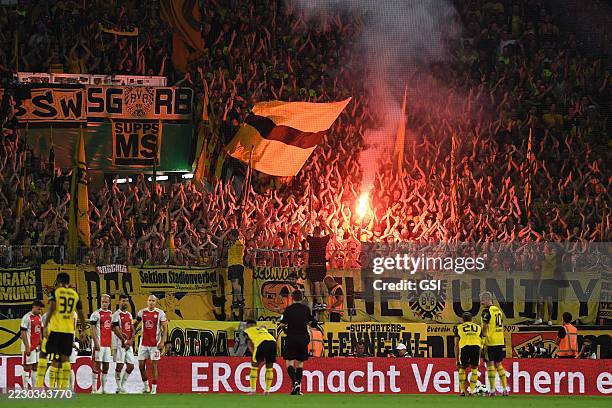 Fans Dortmund supporters use pyrotechnics during the DFB-Pokal match between Rot-Weiss Essen and Borussia Dortmund at Stadion an der Hafenstrasse on...