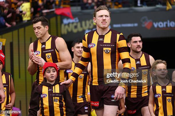Hawthorn players run out before the round 23 AFL match between Hawthorn Hawks and Melbourne Demons at Melbourne Cricket Ground on August 16, 2025 in...