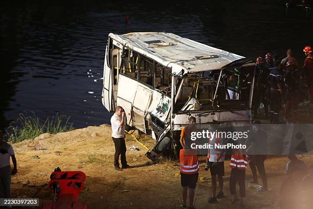Civil protection and diving teams conduct search and rescue operations after a passenger bus falls into the Oued El Harrach River in Algiers,...