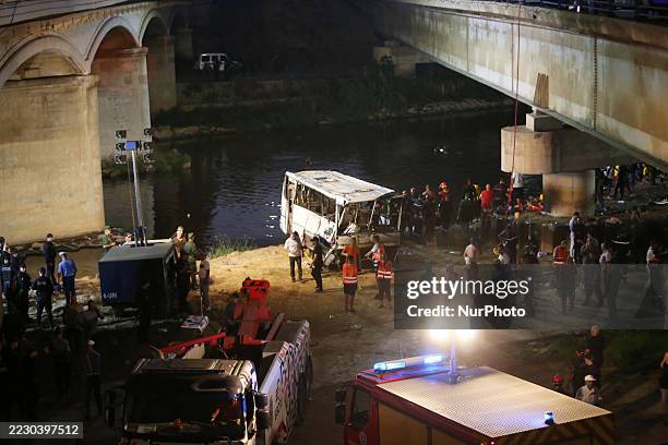 Civil protection and diving teams conduct search and rescue operations after a passenger bus falls into the Oued El Harrach River in Algiers,...