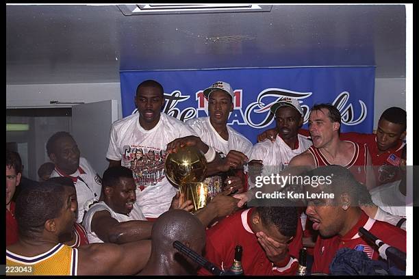 Guard Magic Johnson of the Los Angeles Lakers shakes hands with guard John Paxton of the Chicago Bulls, right, as the Bulls celebrate after defeating...