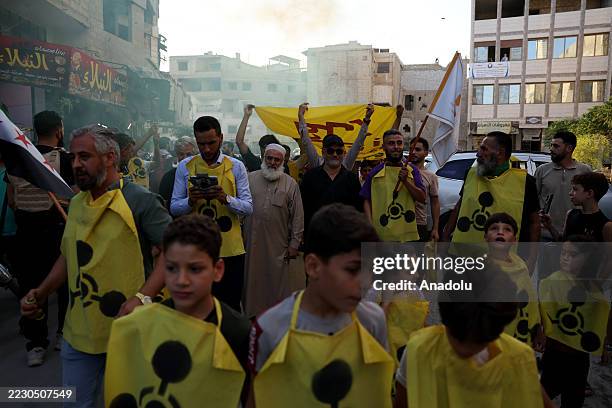 People take part in a march from Gabun to Zamalka to mark the anniversary of chemical attacks in Syria's Eastern Ghouta region, on August 21, 2025....