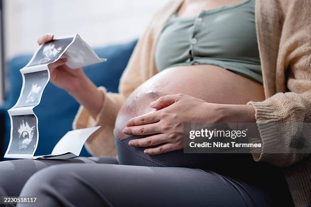 fetal screening with ultrasound. having ultrasound scans can provide you or your midwife with valuable information about your pregnancy and your baby's development. - human fertilisation and embryology authority stock pictures, royalty-free photos & images