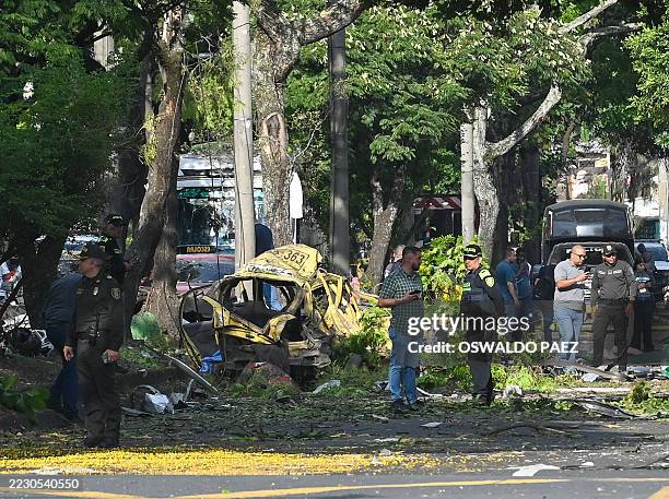 Members of the Colombian police inspect the area of a bomb explosion in Cali, Colombia on August 21 2025. Five people were killed and dozens were...