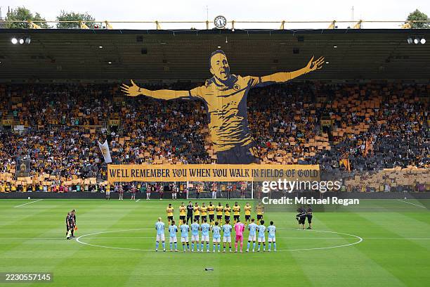 Players of Manchester City and Wolverhampton Wanderers, match officials and fans hold a moment of silence as fans show a tribute in memory of Diogo...