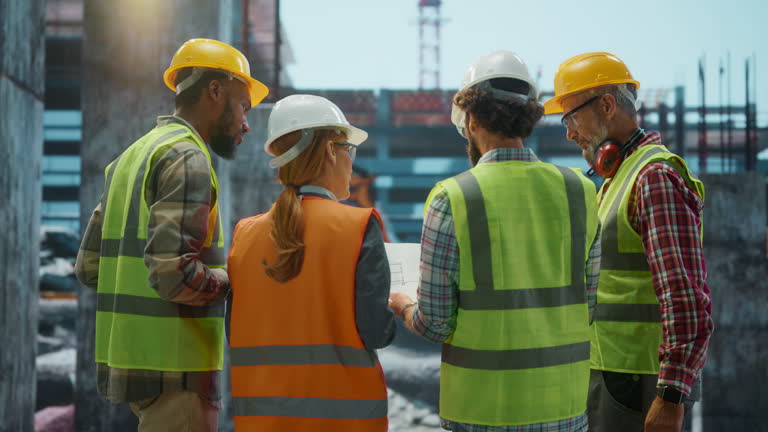 https://media.gettyimages.com/id/2230566348/video/engineers-discussing-blueprint-at-construction-site.jpg?b=1&s=640x640&k=20&c=fk8WYGEdca-OcafoE9TY9TiB6zZGiTAstUp4SqX1gec=
