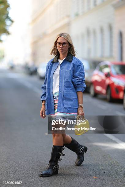 Karin Teigl seen wearing Jacques Marie Mage brown oversized, tortoiseshell sunglasses, Zara loose-fitting cobalt blue suede jacket featuring flap...