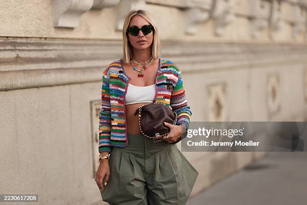 Karin Teigl seen wearing Loewe oversized cat-eye sunglasses, colorful playful beaded necklaces including a cherry pendant, Van Cleef & Arpels gold...