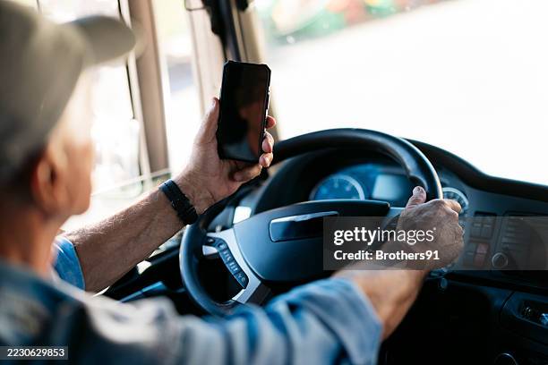 truck driver using smartphone while driving - distracted stock pictures, royalty-free photos & images