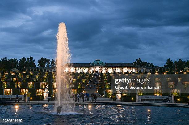 August 2025, Brandenburg, Potsdam: Sanssouci Palace in Sanssouci Park will be illuminated during the 26th Potsdam Palace Night. The event takes place...
