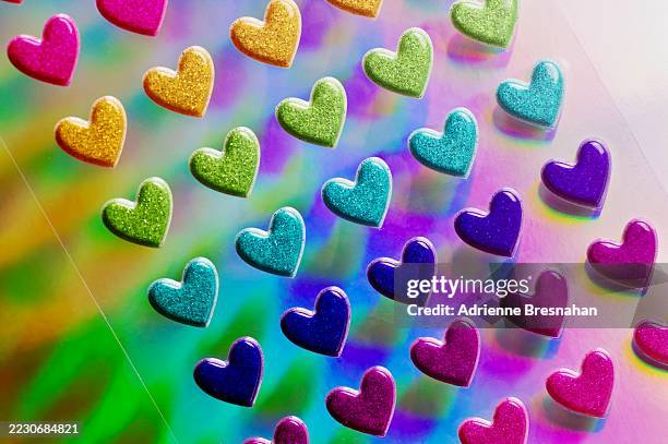 colorful heart stickers against holographic background - holographic foil stock pictures, royalty-free photos & images
