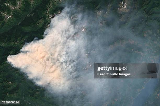 Satellite view of the Bear Gulch Fire shows a dense smoke plume over Mason County, Washington, as crews battle the wildfire burning over 7,000 acres...