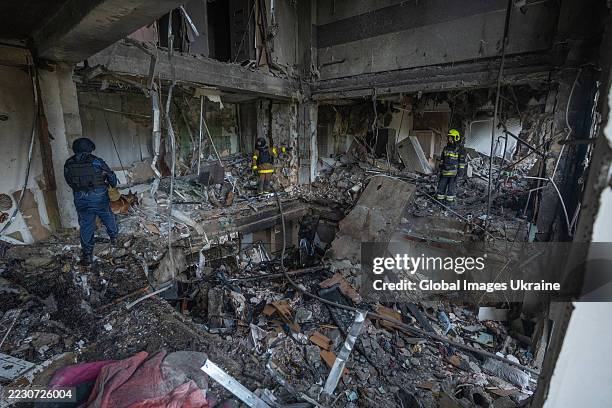 Rescuers clear the rubble in the destroyed apartment building after the Russian drone attack on August 18, 2025 in Kharkiv, Ukraine. In the morning,...