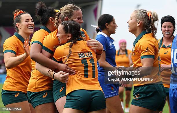 Australia's full back Caitlyn Halse celebrates after scoring the team's third try with Australia's wing Desiree Miller during the Women's Rugby World...