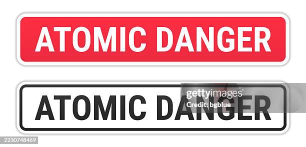 atomic danger - red and black labels on white background - environmental protest stock illustrations
