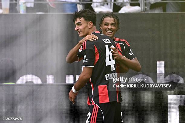 Frankfurt's French forward Jean-Matteo Bahoya celebrates scoring his team's third goal with Frankfurt's Turkish forward Can Uzun during the German...