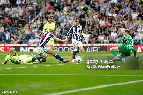Connor Ogilvie of Portsmouth fouls Aune Heggebo of West Bromwich Albion inside the penalty area but referee says play on no penalty kick during the...