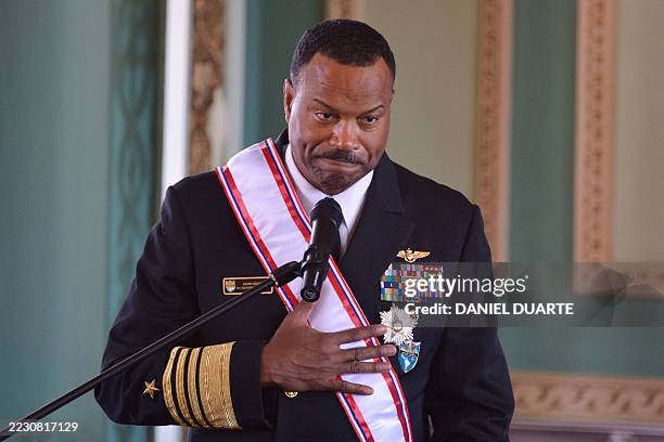 The head of the US Southern Command, Admiral Alvin Holsey, gestures after being decorated with the Order of Merit of the Military Forces Command...