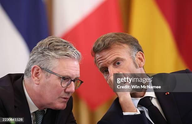 British Prime Minister Keir Starmer and French President Emmanuel Macron speak with each other during a meeting with U.S. President Donald Trump,...