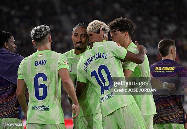 Barcelona's Spanish forward Lamine Yamal celebrates with teammates Levante's Spanish defender Unai Elgezabal own goal during the Spanish league...