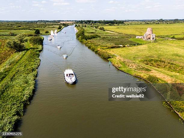 sailing by st benet's abbey - norfolk broads stock pictures, royalty-free photos & images