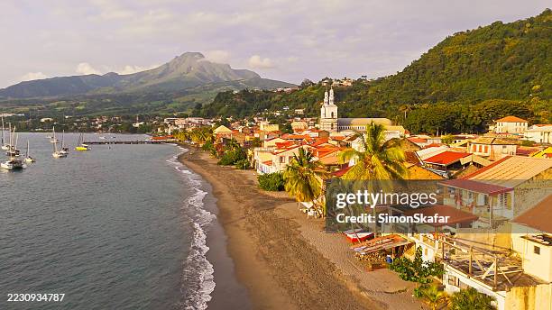 charming coastal town in dominica with sandy beach and sailboats - caribbean culture stock pictures, royalty-free photos & images