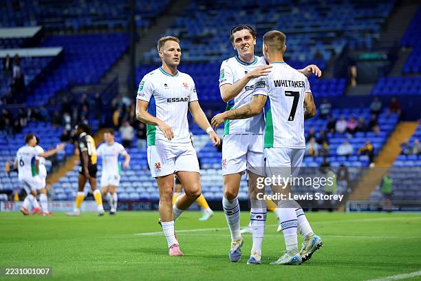 Charlie Whitaker of Tranmere Rovers celebrates scoring his team's first goal with Cameron Norman and Sol Solomon during the Carabao Cup First Round...