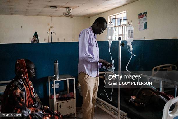 Nurse prepares an IV drip for a patient suffering from malaria at the Bunj Hospital in Maban, on August 19, 2025. Over 200,000 people in four refugee...