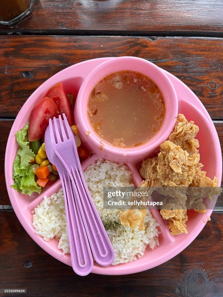Colorful Kids Meal with Fried Chicken, Rice, Vegetables, and Soup in Pink Plate