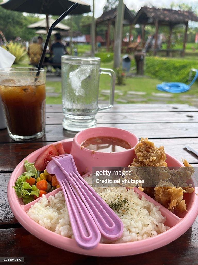 Colorful Kids Meal with Fried Chicken, Rice, Vegetables, and Soup in Pink Plate