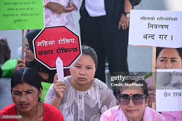 Women's rights activists hold a sit-in protest carrying traditional nanglo trays at Maitighar Mandala in Kathmandu, Nepal, on August 24, 2025. The...