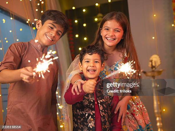 friends enjoying with sparklers at home during diwali - diwali stock pictures, royalty-free photos & images