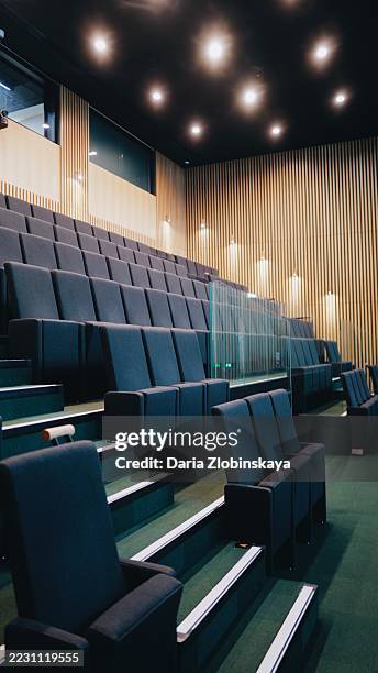 empty front seats of the audience section in an auditorium at the london city hall - school auditorium stock pictures, royalty-free photos & images
