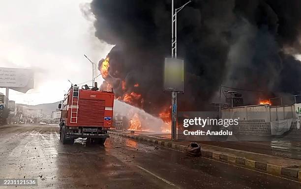 Firefighters try to extinguish the fire following the Israeli warplanes struck several sites in capital Sanaa, including the presidential palace and...