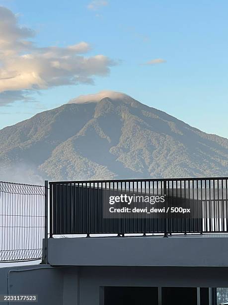 misty mountain view with building in foreground,bukittinggi,indonesia - bukittinggi stock pictures, royalty-free photos & images