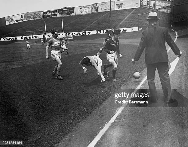 Gaelic football players in action at Yankee Stadium, New York, circa 1934. Pitch-side boards advertise brands including Horton's Ice Cream, Philip...