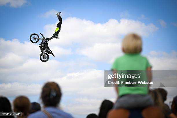 Jamie Squibb entertains the crowds with a Freestyle Motocross Arena Stunt Show at the Melplash Agricultural Society Show, on August 21, 2025 in West...