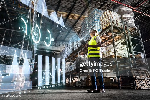 Employee analyzing virtual data with augmented reality interface in a warehouse Employee analyzing virtual data with augmented reality interface in a warehouse