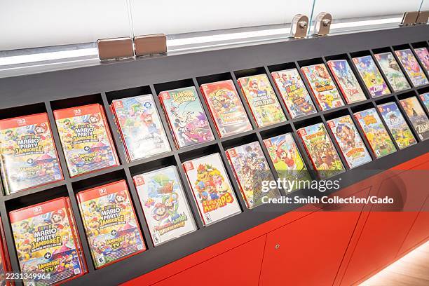 Assorted Nintendo Switch game cases including Mario and Zelda titles in glass retail display, San Francisco, California, August 19, 2025.