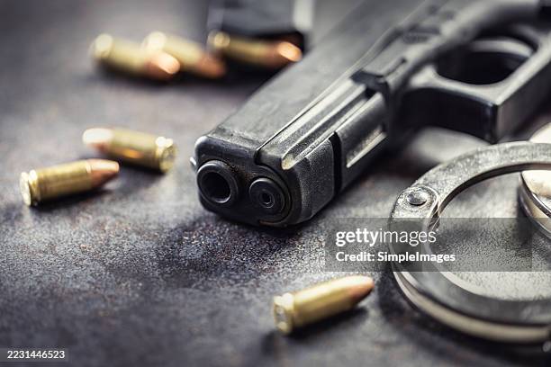 police pistol, bullets, lantern and handcuffs. - sparare foto e immagini stock