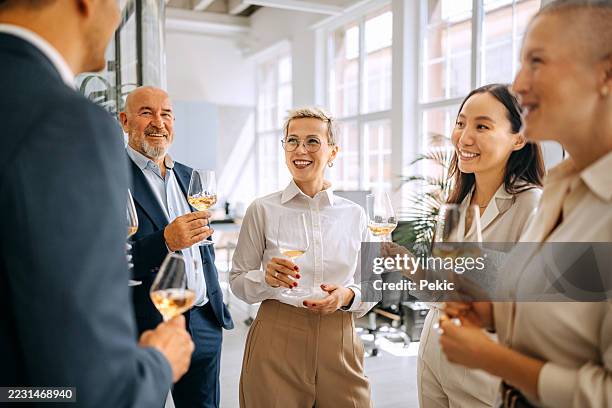 group of colleagues having wine together at office - formal businesswear stock pictures, royalty-free photos & images