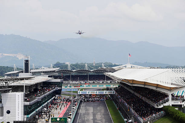 Sepang International Circuit, Sepang, Malaysia. Sunday 01 October 2017. A jet flies over the pit straight ahead of the start.