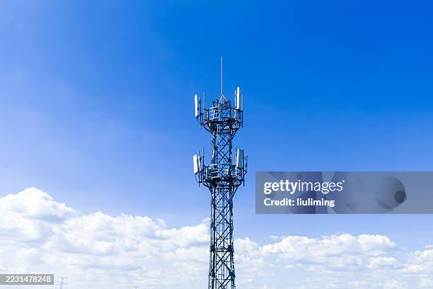 drone aerial view of 5g communication tower against blue sky - wireless tower stock pictures, royalty-free photos & images