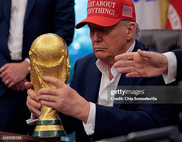 President Donald Trump holds the World Cup Trophy in the Oval Office August 22, 2025 in Washington, DC. Trump announced the FIFA World Cup 2026 draw...