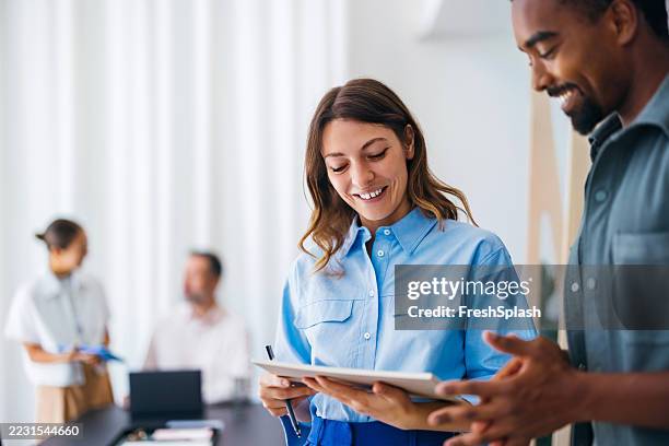 business team collaborating and discussing during a productive office meeting - klanten georiënteerd stockfoto's en -beelden