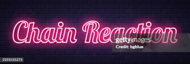 chain reaction - glowing neon text on brick wall background - chain reaction graphics stock illustrations