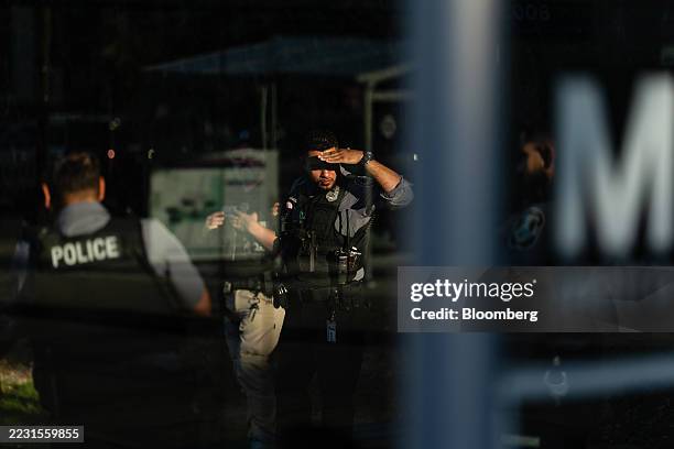 Metrotransit officers watch commuters board a bus during a fare evasion enforcement at the Fort Totten Metro Station in Washington, DC, US, on...